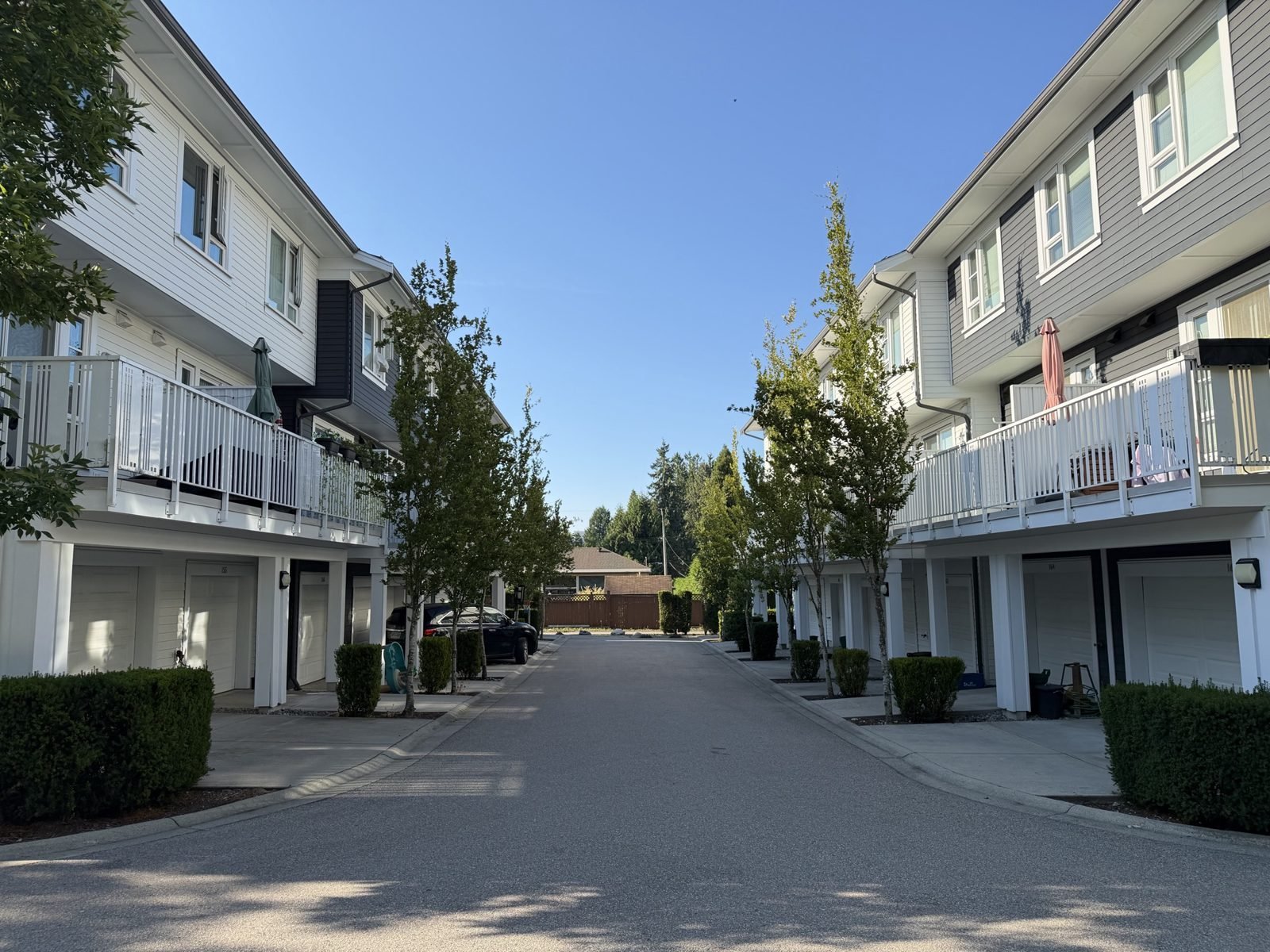 Foster townhomes with white balconies, Coquitlam